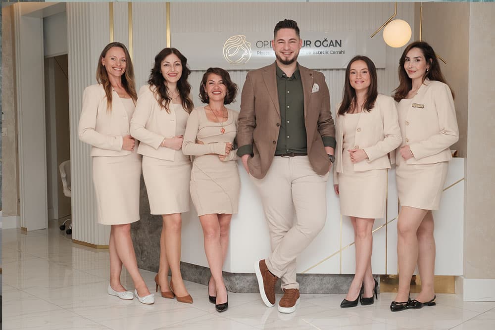 Op. Dr. Onur Oğan with his clinic team at the reception desk