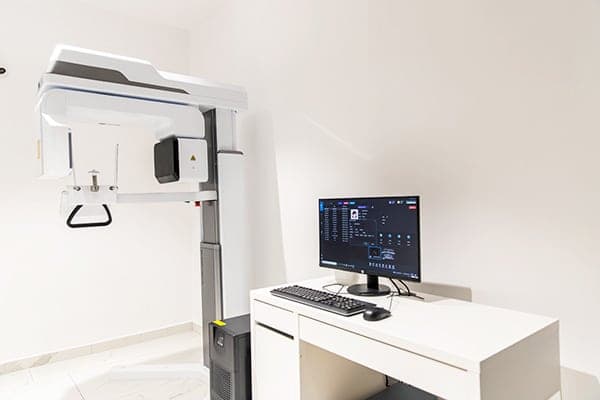 The imaging room at Focus Dental Clinic, with a panoramic X-ray unit and a workstation