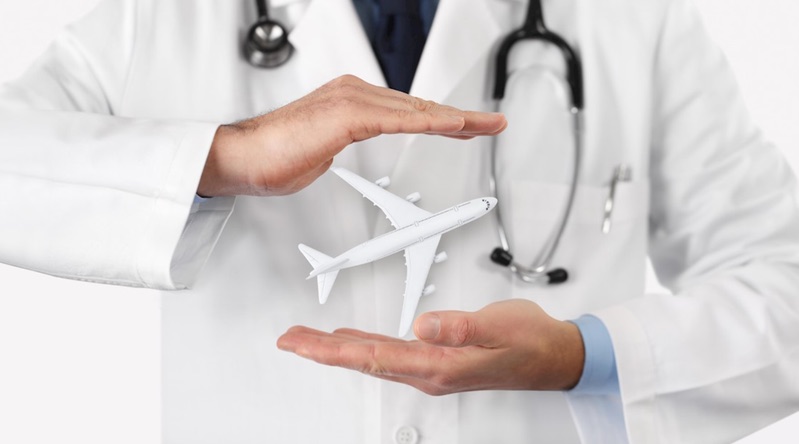Doctor’s hands cupped protectively around a model airplane